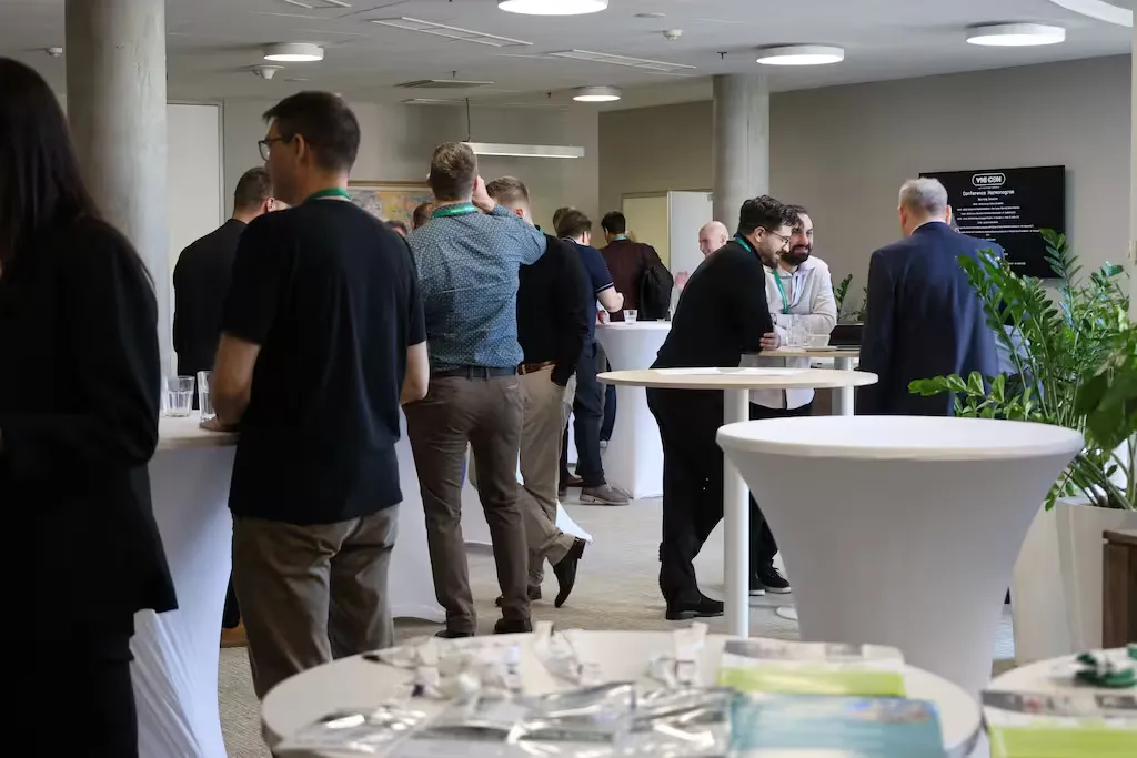 Conference attendees networking during break